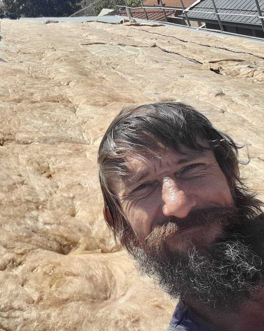 Shawn Dhu on a new-build roof after laying under-sheet insulation